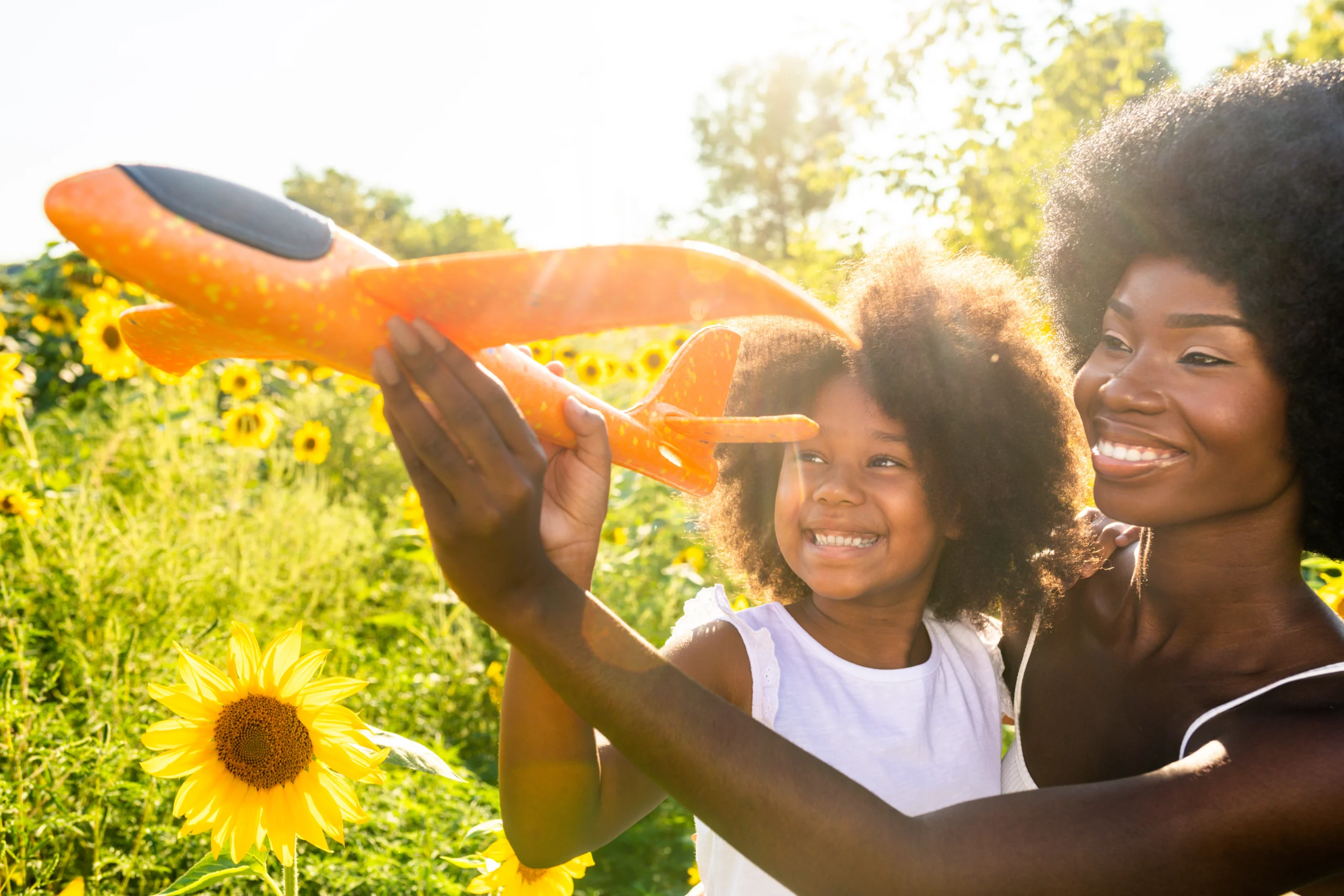 Beautiful mom and daughter in a sunflowers field 2026 01 11 11 12 17 utc
