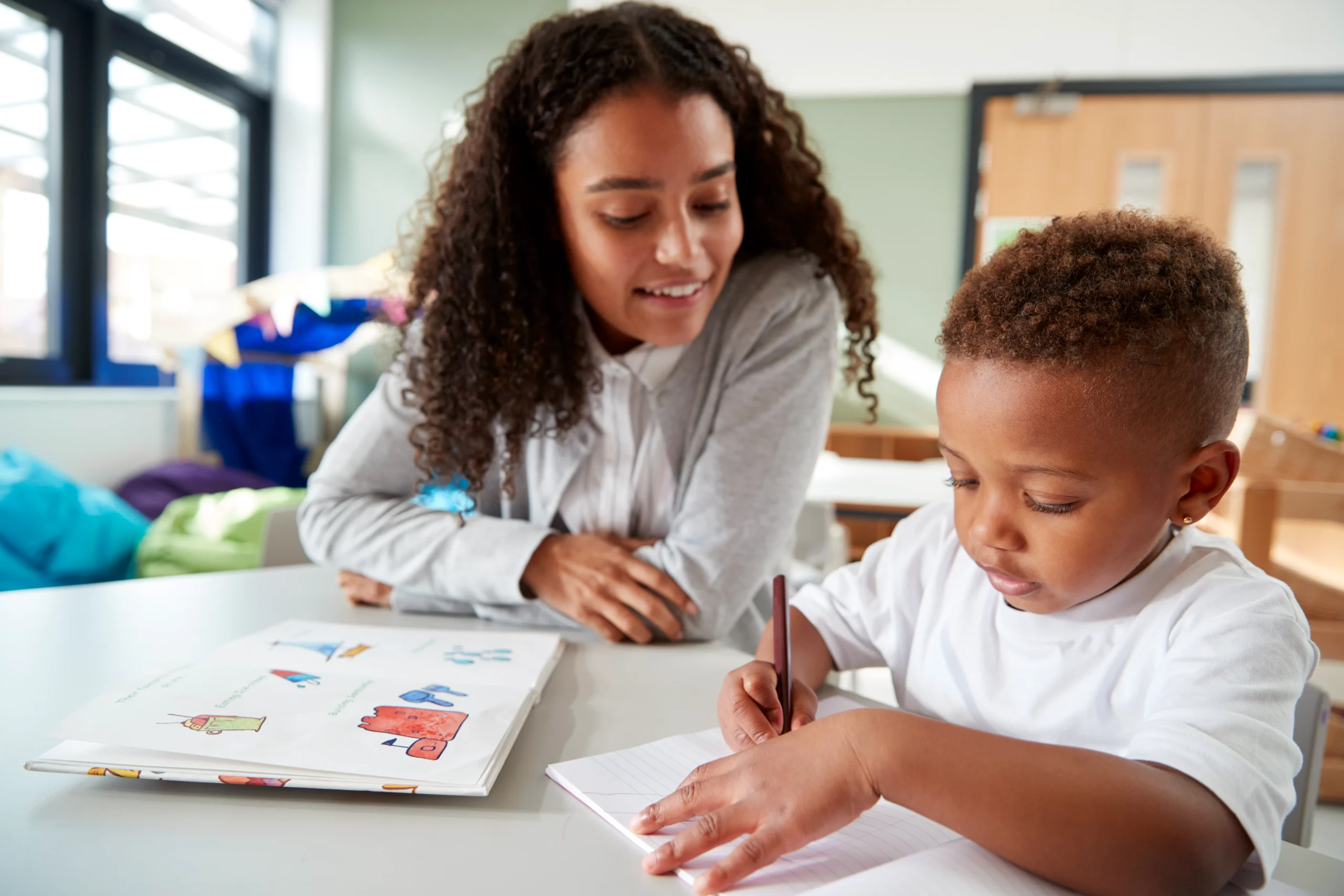 Female infant school teacher working one on one wi 2026 01 05 06 28 05 utc