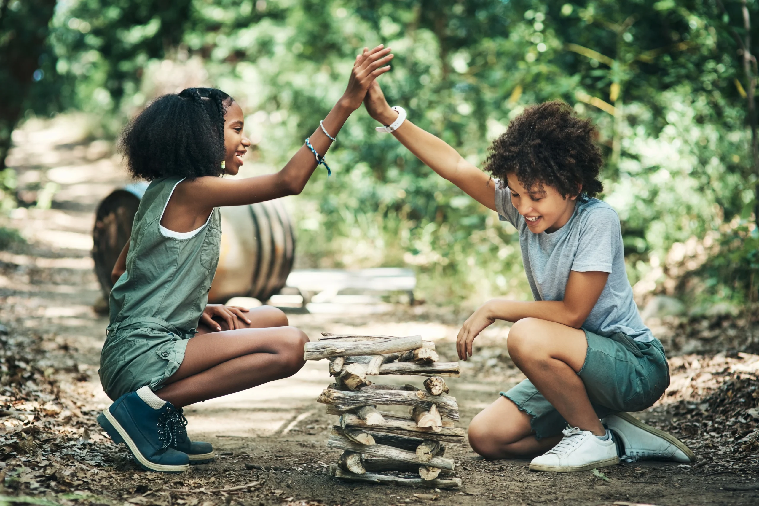 Two children building a stack of sticks 2026 01 09 09 55 30 utc